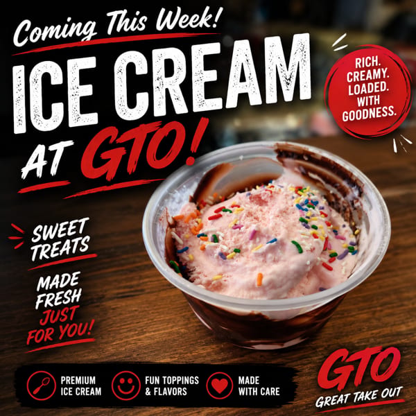 Strawberry ice cream with colorful sprinkles and chocolate syrup in a clear cup on a wooden table.