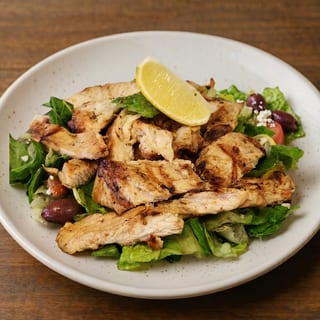 Grilled or Cajun Chicken Over Greek, Caesar or Leaf Salad